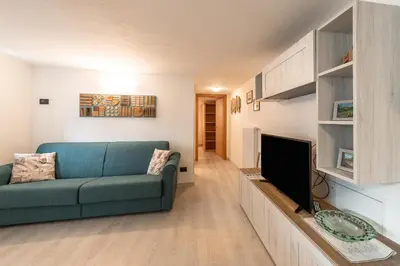 a living room with a couch and a flat screen tv at Appartamento Ciasa Ciaslir in Vigo di Fassa