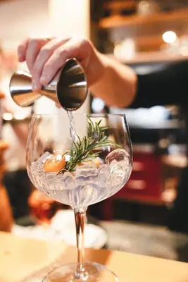 a person pouring wine into a wine glass at Hotel Avelina in Avelengo