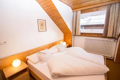 two beds in a room with a window at Residence Chris Appart in Carezza al Lago