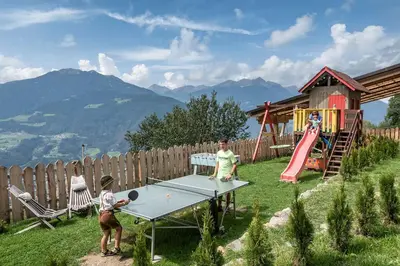 a group of people playing ping pong in a yard at Nussbaumerhof in Bressanone