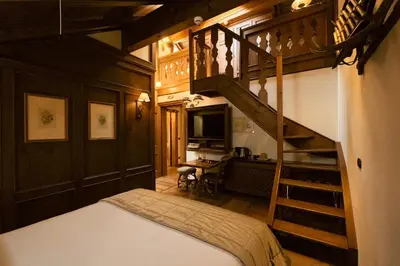 a bedroom with a bed with a black and white wall at Ambra Cortina Luxury&Fashion Hotel in Cortina dʼAmpezzo