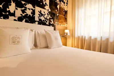 a dining room with a table and a wall of pictures at Ambra Cortina Luxury&Fashion Hotel in Cortina dʼAmpezzo
