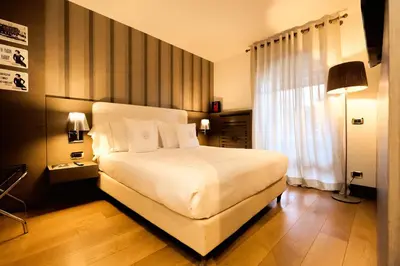 a bedroom with a bed with a mirror at Ambra Cortina Luxury&Fashion Hotel in Cortina dʼAmpezzo