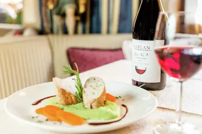 a white plate with a sandwich and salad on it at Hotel Stefaner in Tires