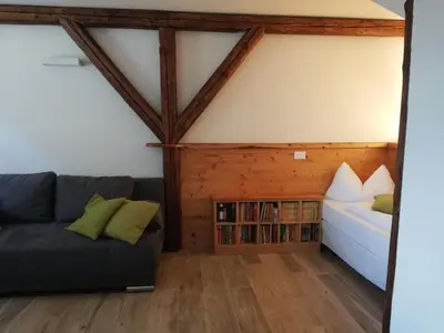 a living room with a couch and a bed at Casa Lassù in Carano
