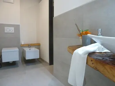 a bathroom with a sink and a toilet at Casa Lassù in Carano