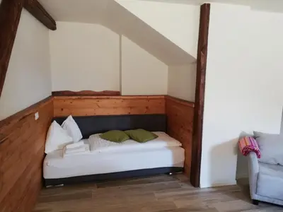 a room with a bed in the corner of a room at Casa Lassù in Carano
