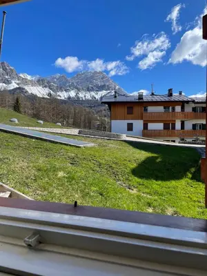 a view from a window of a building with mountains at La Roncolina in Cortina dʼAmpezzo