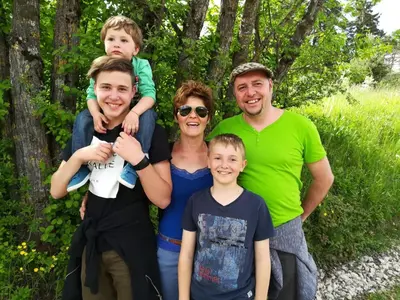 a family is posing for a picture together at Garni Reider in Meltina