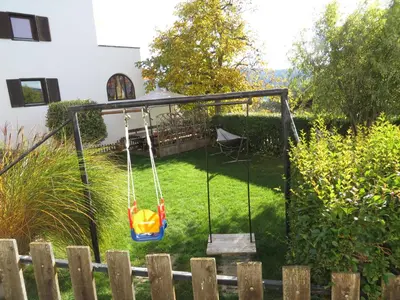 a swing in the backyard of a house at Garni Reider in Meltina