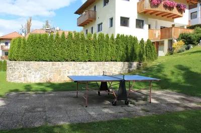 a ping pong table in front of a building at Villa Tanja in Castelrotto