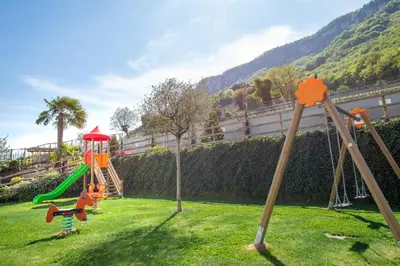 a park with a playground with a slide at Vineus Tramin in Termeno