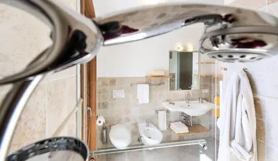 a bathroom with a sink and a toilet at Apartments Elisir in Castelrotto