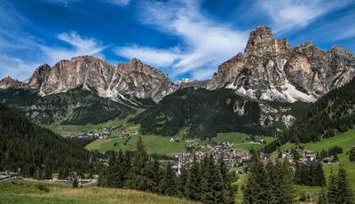a village in a valley in the mountains at Nei Y Suredl NeveSole in Corvara in Badia