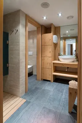 a bathroom with a tub and a sink and a bath tub at Nei Y Suredl NeveSole in Corvara in Badia