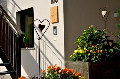 a stairway with a heart on the side of a building at Appartements Mayrhof in Bressanone