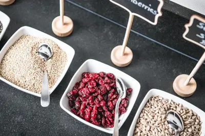 a table with four dishes of food with cranberries at Garni Hotel Miara - Your Dolomites Home in Selva di Val Gardena