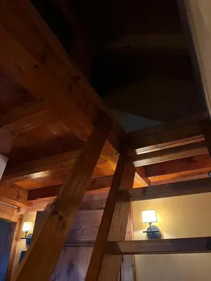 a wooden ceiling with two lamps in a room at Castel Madonna in San Martino di Castrozza