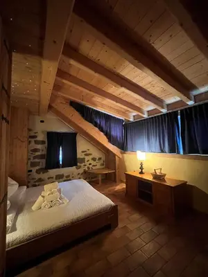 a bedroom with a bed and a desk in a room at Castel Madonna in San Martino di Castrozza