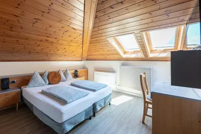 a bedroom with a bed and a tv in a room at Gasthof Salurn in Salorno sulla Strada del Vino
