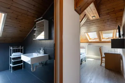 a bathroom with a sink and a room with a bed at Gasthof Salurn in Salorno sulla Strada del Vino