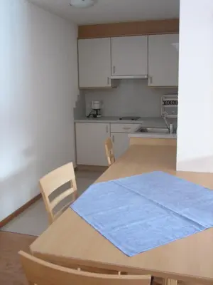 a kitchen with a table with a blue towel on it at Garni - Appartement Neumairhof in Rasun di Sopra