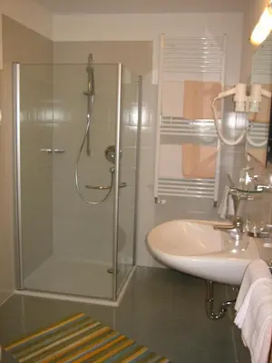 a bathroom with a shower and a sink at Garni - Appartement Neumairhof in Rasun di Sopra