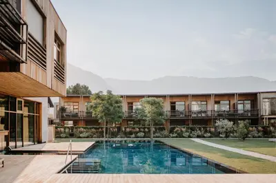 an external view of a building with a swimming pool at VillaVerde Aparthotel in Lagundo