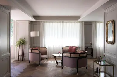 a living room with chairs and a table and a window at VillaVerde Aparthotel in Lagundo