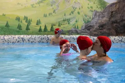 a group of people in a swimming pool at Hotel San Marco in Passo San Pellegrino