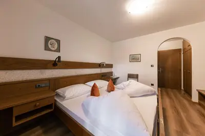 a bedroom with two beds and a mirror at Hotel Fines in Funes
