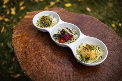 three bowls of food sitting on a wooden table at Hotel Fines in Funes