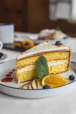 a piece of cake on a plate on a table at Hotel Fines in Funes