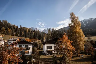 a view of a house in the mountains with trees at Hotel Fines in Funes