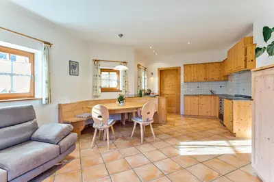 a kitchen and living room with a couch and a table at Gasserhof in Barbiano