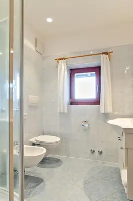 a bathroom with a toilet and a sink at Gasserhof in Barbiano