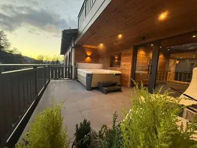 a large room with a stone wall and a table at Hotel Rio Bianco in Panchia