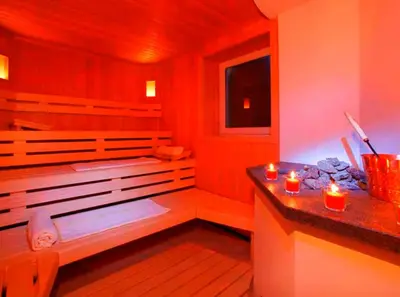 a room with a sauna with candles on a counter at Hotel Ingram in Selva di Val Gardena