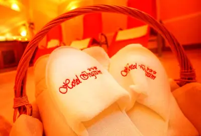 a basket filled with white towels with writing on them at Hotel Ingram in Selva di Val Gardena
