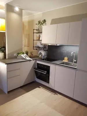 a kitchen with white cabinets and a sink at Ihr neuer Lieblingsplatz in Meran in Merano