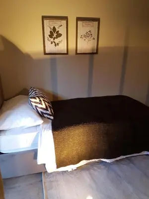 a bedroom with a bed with two pictures on the wall at Ihr neuer Lieblingsplatz in Meran in Merano