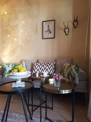 a living room with two tables and two couches at Ihr neuer Lieblingsplatz in Meran in Merano