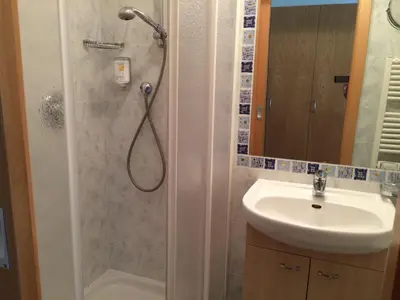 a bathroom with a shower and a sink at Hotel Garni Paler in Tirolo