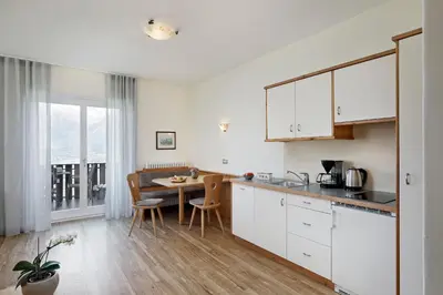 a kitchen with a table and a dining room at Landhaus Weger in Merano