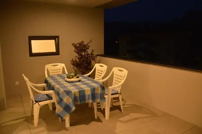 a dining room table with a blue and white checkered table cloth at Family Apartment Julia in Termeno