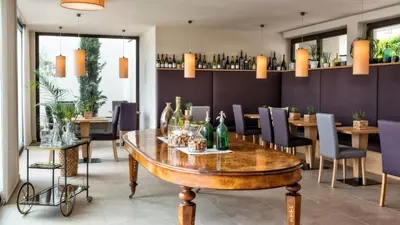 a dining room with a table with bottles on it at Die Sonne in Kaltern in Caldaro