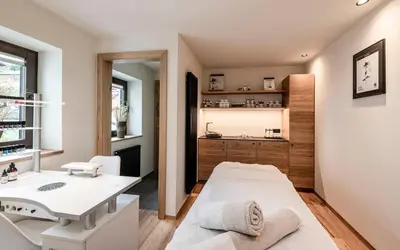 a bathroom with a bed and a sink in a room at Viel Nois Guest House in Funes