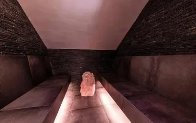 a room with benches and a rock on the floor at Viel Nois Guest House in Funes