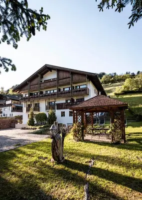 a large building with a gazebo and a statue at Raschötzhof in Funes