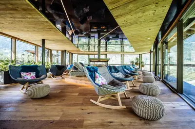 a room with chairs and tables and windows at Andreus Resorts in San Leonardo in Passiria